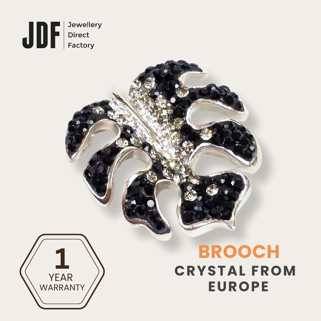 Iconic Monstera Leaf Brooch with Crystals from Europe, Brooch, Black, Crystals from Europe, One-Year Warranty - Jewellery Direct Factory in alabaster background