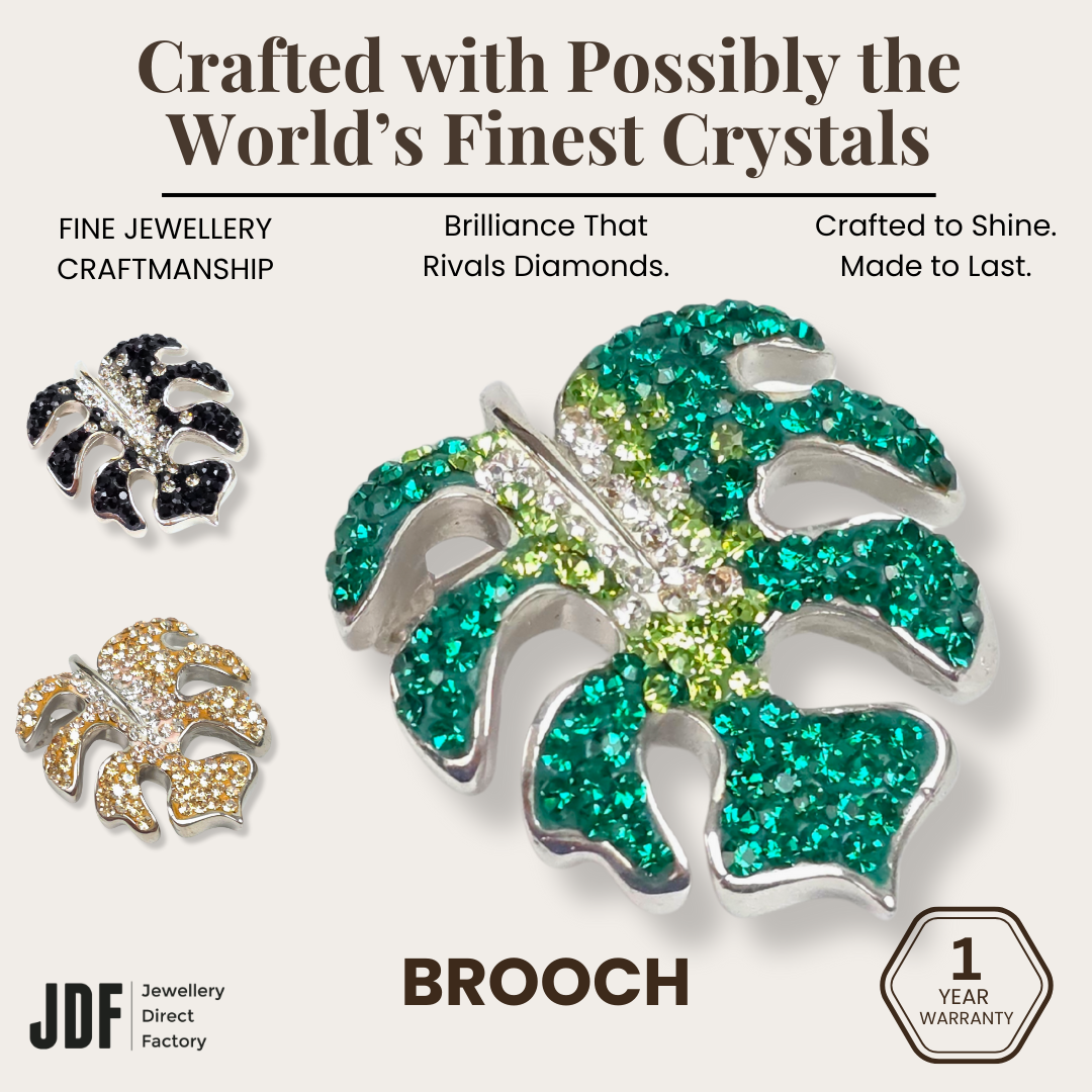 Iconic Monstera Leaf Brooch with Crystals from Europe, Brooch, Beige, Green, Black, Crystals from Europe, One-Year Warranty - Jewellery Direct Factory in alabaster background