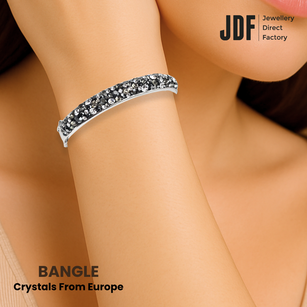 Luminous Pavé Hinge Bangle with Crystal From Europe, Crystal Bangle, Worn by Woman Model, Black, Crystal From Europe, One-Year Warranty - Jewellery Direct Factory in alabaster background