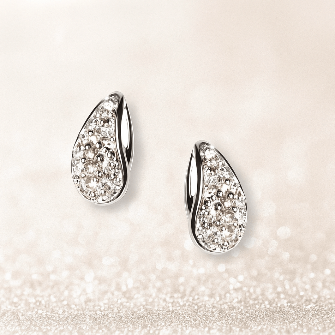 A pair of teardrop crystal stud earrings displayed on a shiny white background, highlighting their sparkle and graceful design